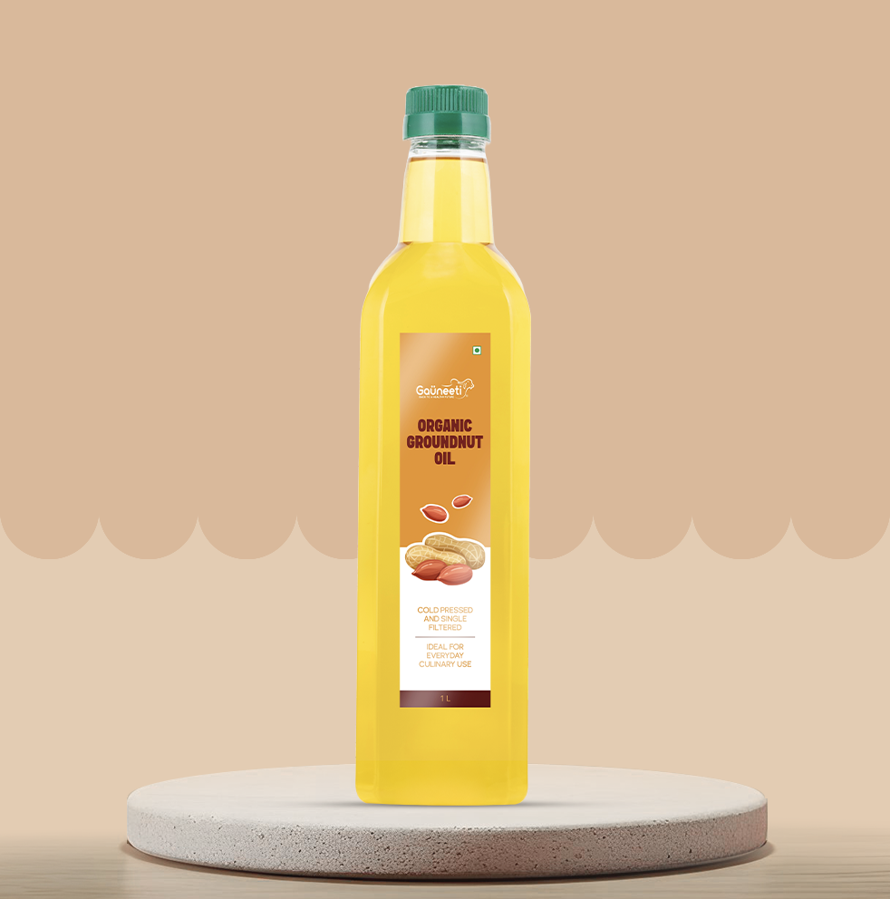 Bottle of organic groundnut oil on a beige background.