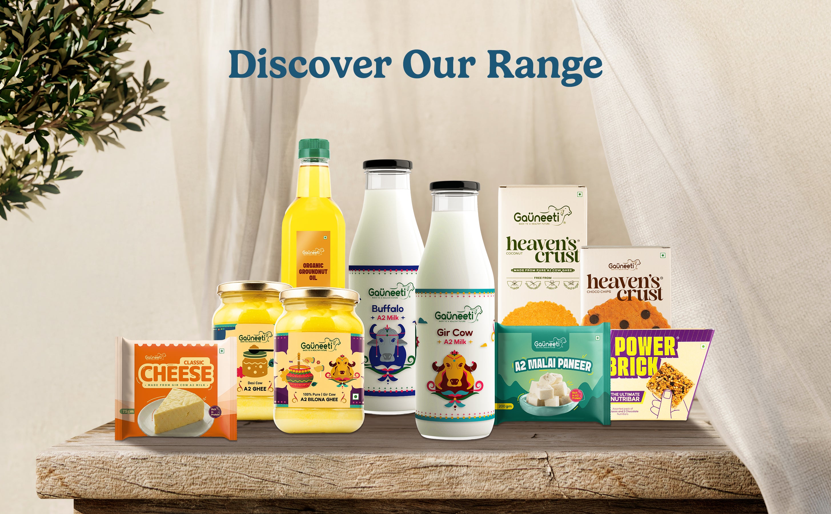 Assorted food products including bottles and boxes on a wooden surface with a neutral background.