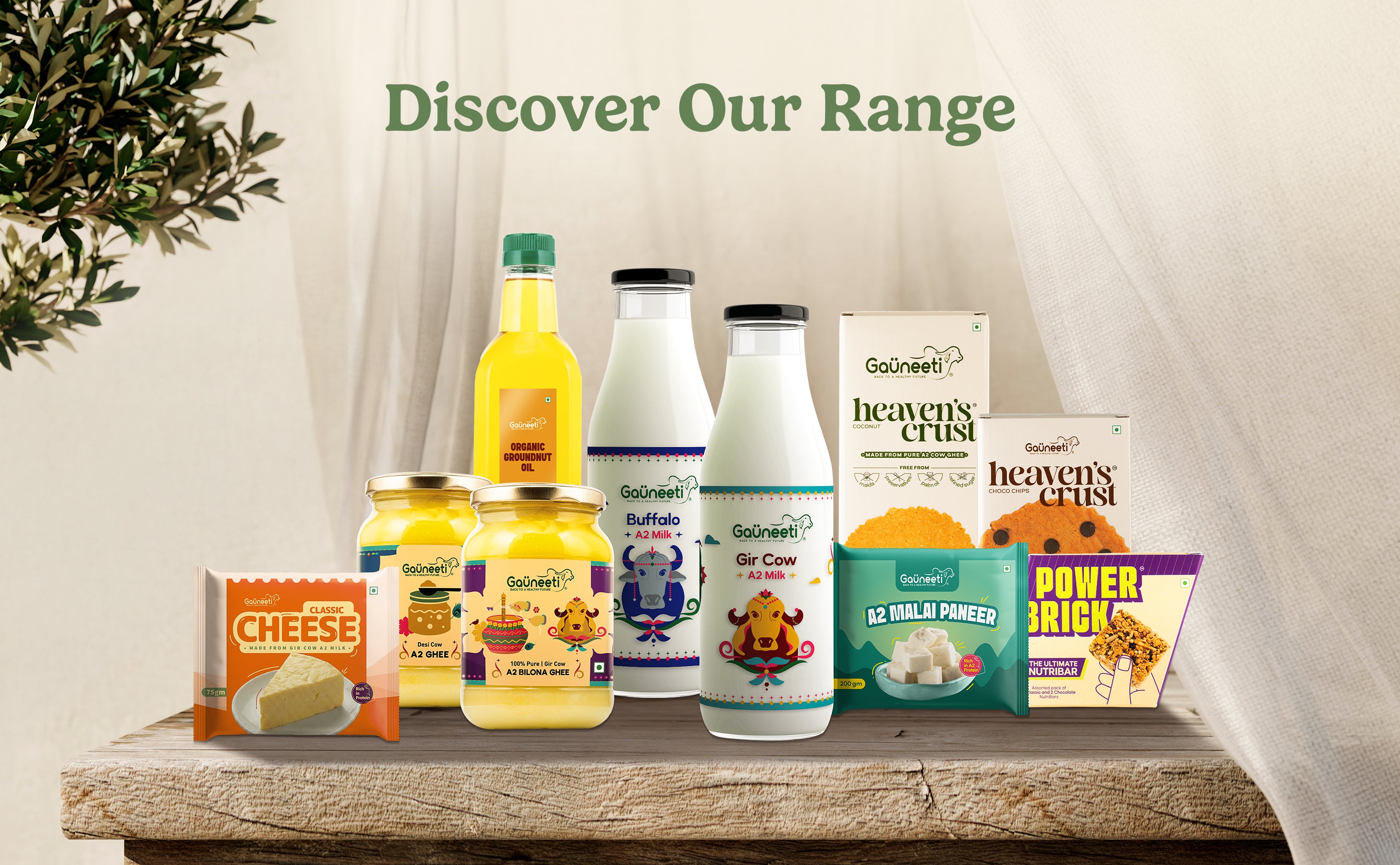 Assorted food products including bottles, jars, and boxes on a wooden surface with a neutral background.