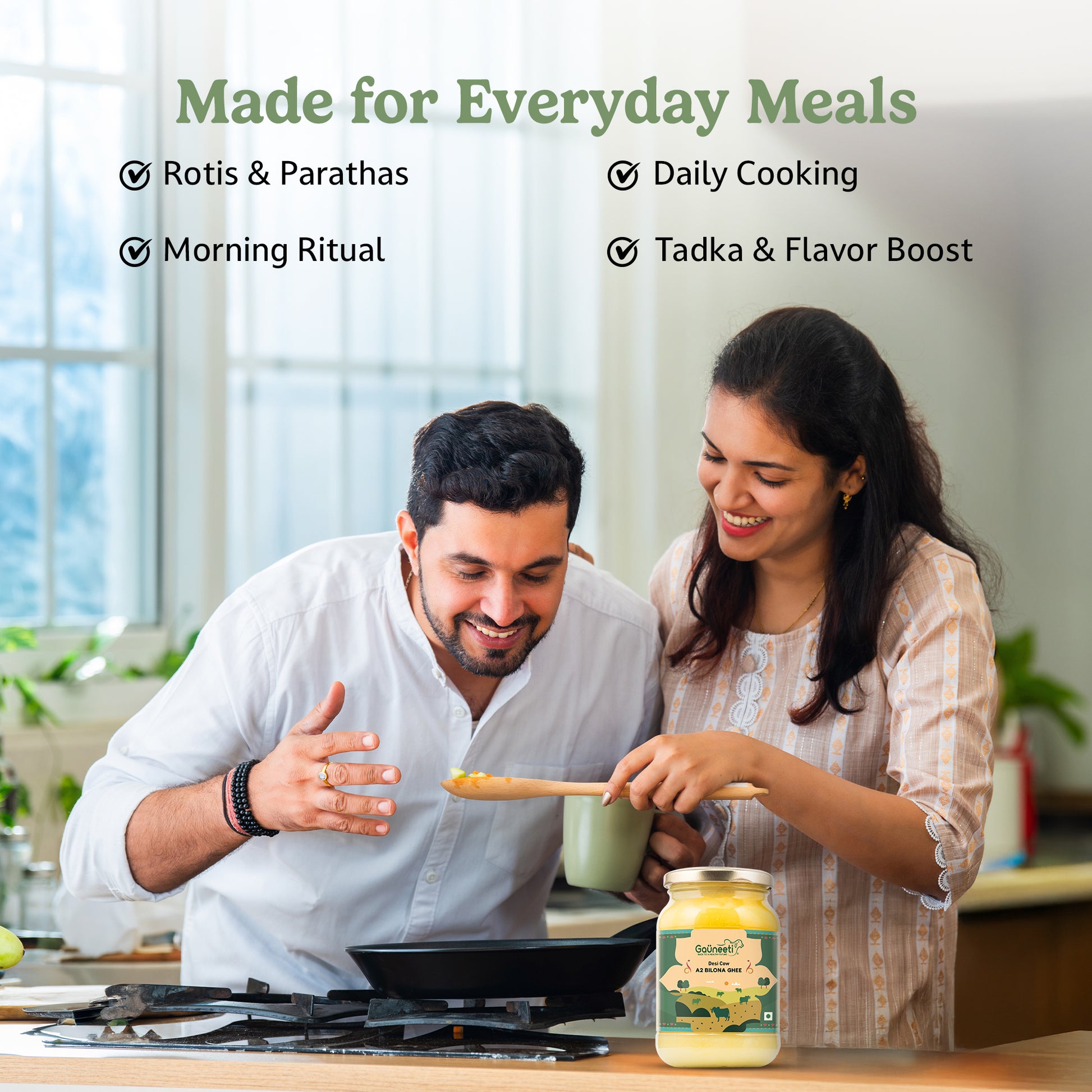 Man and woman cooking together in a kitchen with a jar of Gauneeti ghee on the counter.