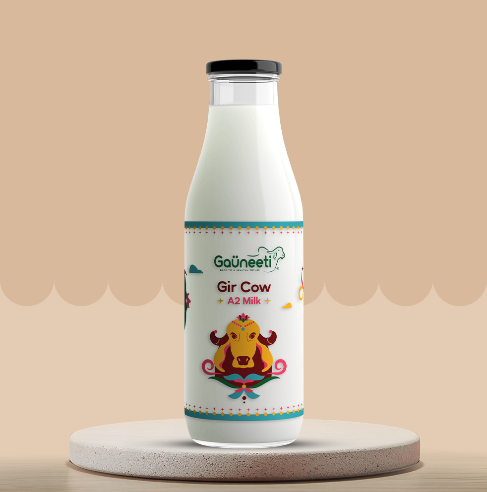Gauneeti's Gir cow A2 Milk bottle with a colorful label on a beige background.